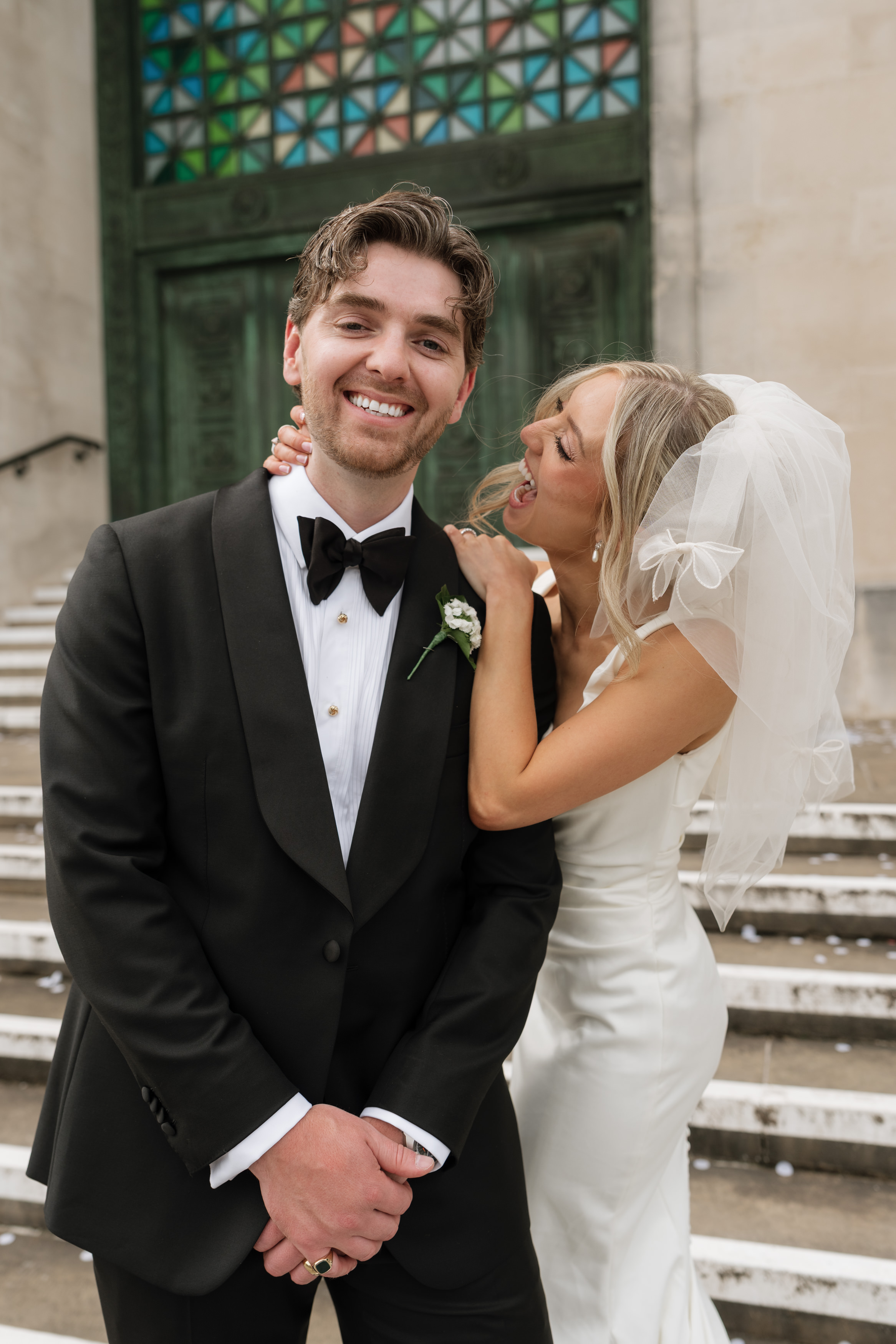 Hannah leaning towards Andrew as he smiles on the Guildhall steps.